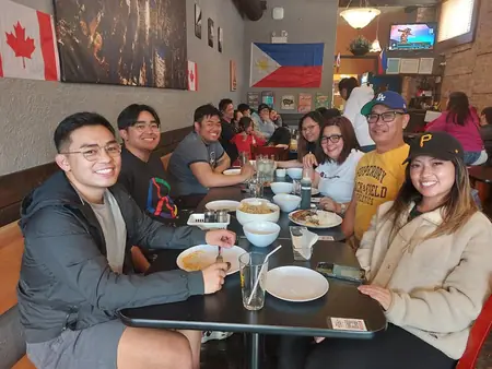 Guests sharing a meal at Kuya Will's restaurant in Lethbridge