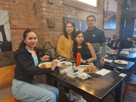 Guests sharing a meal at Kuya Will's restaurant in Lethbridge