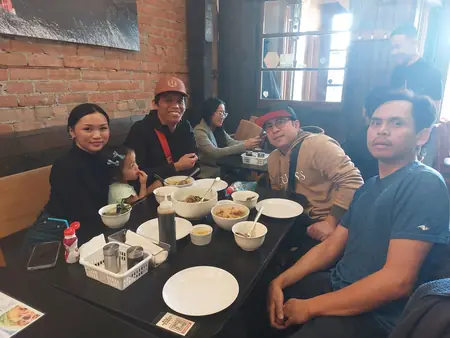 Guests sharing a meal at Kuya Will's restaurant in Lethbridge