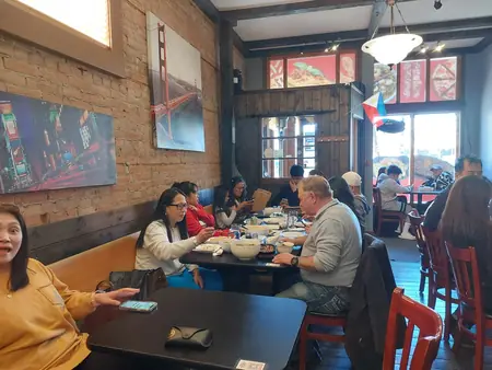 Guests sharing a meal at Kuya Will's restaurant in Lethbridge